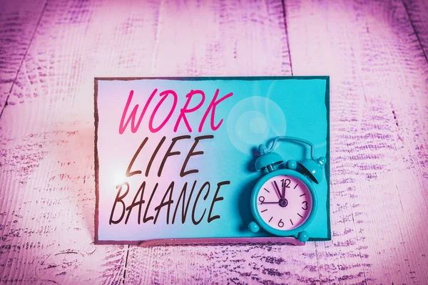 Conceptual hand writing showing Work Life Balance. Concept meaning Division of time between working or family and leisure Alarm clock tilted above buffer wire in front of notepaper