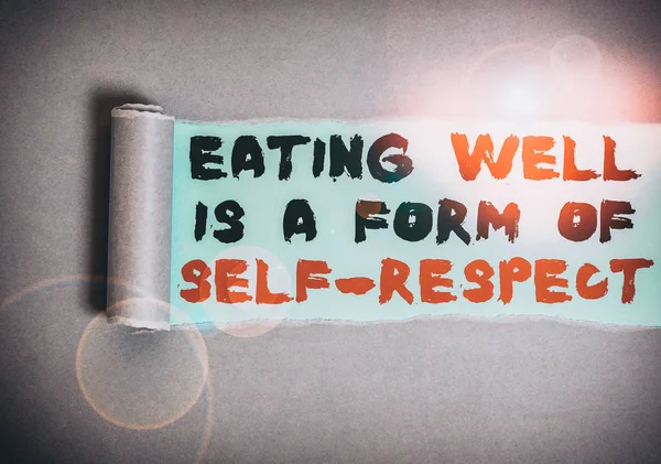 Handwriting text Eating Well Is A Form Of Self Respect. Conceptual photo a quote of promoting healthy lifestyle Cardboard which is torn in the middle placed above a plain table backdrop