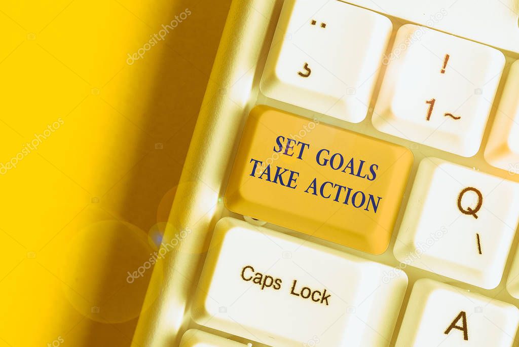 Writing note showing Set Goals Take Action. Business concept for Act on a specific and clearly laid out plans White pc keyboard with note paper above the white background