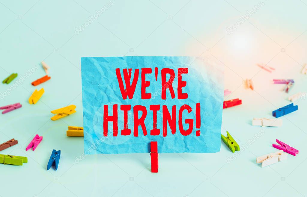 Writing note showing We Re Hiring. Business concept for recently employ someone or pay someone to do particular job Colored clothespin rectangle square shaped paper light blue background