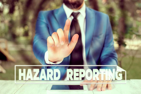Writing note showing Hazard Reporting. Business concept for account or statement describing the danger or risk Businessman with pointing finger in front of him