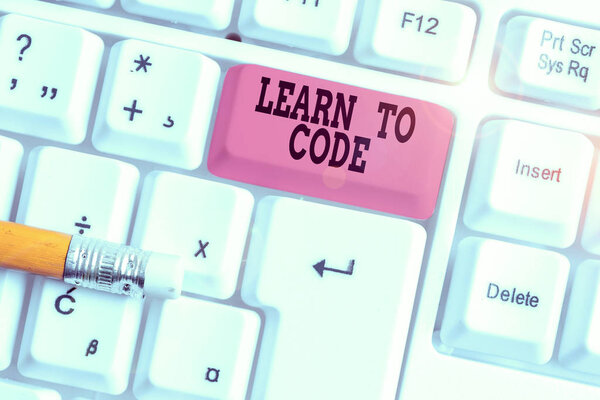 Word writing text Learn To Code. Business photo showcasing Learn to write Software Be a Computer Programmer Coder White pc keyboard with empty note paper above white background key copy space