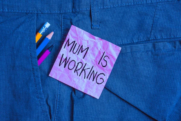 Text sign showing Mum Is Working. Business photo text Financial Empowerment and professional progressing mother Writing equipment and pink note paper inside pocket of man work trousers