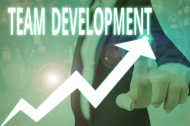 Conceptual hand writing showing Team Development. Concept meaning the enhancement of the effectiveness of work groups clipart