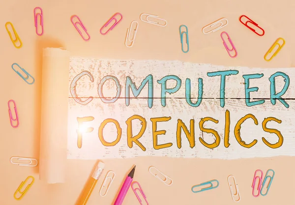 Text sign showing Computer Forensics. Business photo showcasing the investigative analysis techniques on computers Stationary and torn cardboard placed above a wooden classic table backdrop