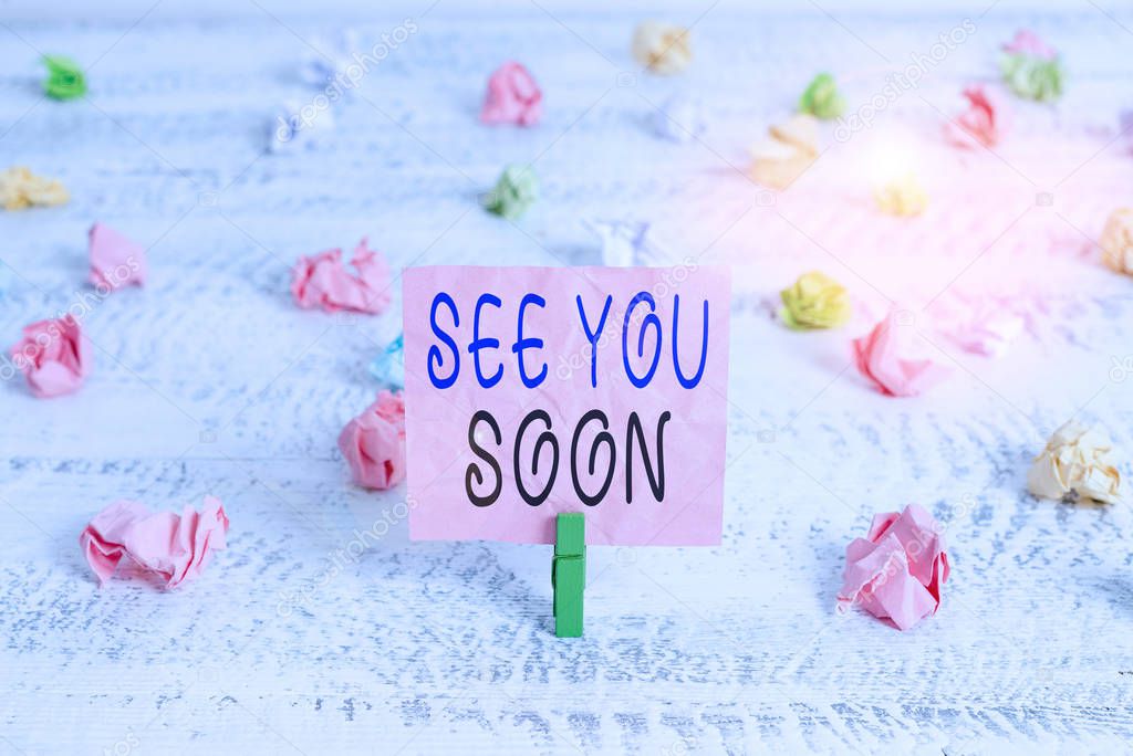 Handwriting text See You Soon. Conceptual photo used for saying goodbye to someone and going to meet again soon Green clothespin white wood background colored paper reminder office supply