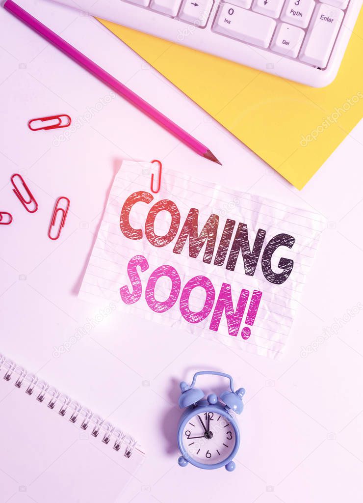 Text sign showing Coming Soon. Business photo text event or action that will happen after really short time Flat lay above white blank paper with copy space for text messages