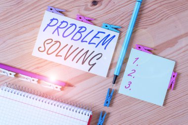 Kavramsal el yazısı problem çözmeyi gösteriyor. Zor ya da karmaşık sorunlara çözüm bulma süreci kavramı Renkli buruşmuş kağıtlar ahşap zemin mandalı