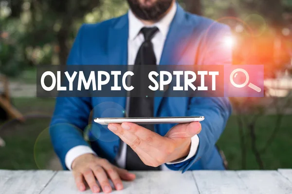 Text sign showing Olympic Spirit. Business photo showcasing having pride in your national team but putting aside politics Businessman with mobile phone in his hand