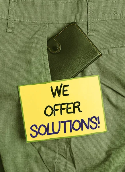 Handwriting text writing We Offer Solutions. Conceptual photo Offering help assistance Experts advice strategies ideas Small little wallet inside man trousers front pocket near notation paper