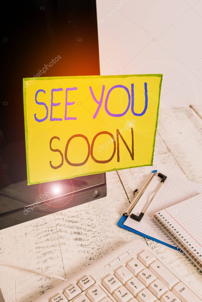 Word writing text See You Soon. Business photo showcasing used for saying goodbye to someone and going to meet again soon Note paper taped to black computer screen near keyboard and stationary