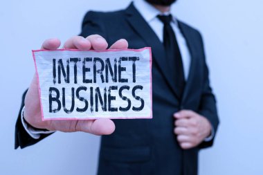 Word writing text Internet Business. Business concept for business or commercial transactions that take place online Male human wear formal work suit office look hold notepaper sheet use hand.