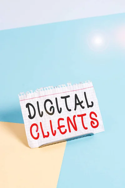 Text sign showing Digital Clients. Business photo text use digital channels to consume content or engage with brand Paper placed tilted above buffer wire on soft pastel multi colours backdrop