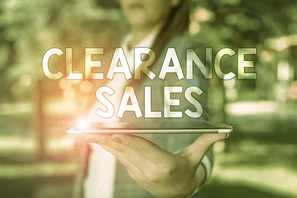 Conceptual hand writing showing Clearance Sales. Business photo text goods at reduced prices to get rid of superfluous stock Outdoor scene with business woman holds lap top with touch screen.