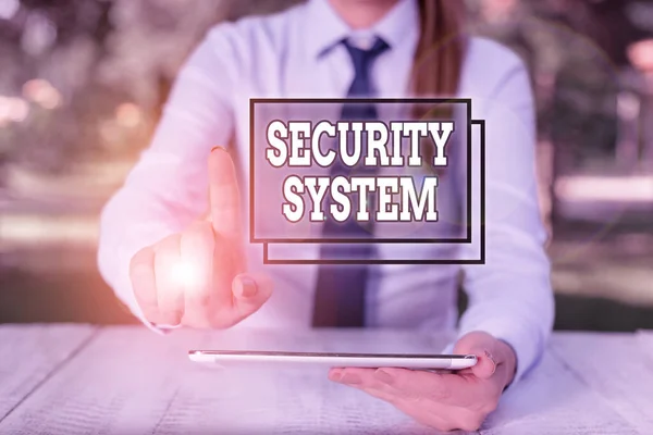 Conceptual hand writing showing Security System. Business photo text system designed to detect intrusion or unauthorized entry Female business person sitting by table and holding mobile phone. — Stock Photo, Image