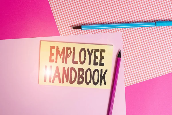 Conceptual hand writing showing Employee Handbook. Concept meaning states the rules and regulations and policies of a company writing equipments and plain note paper placed on the table