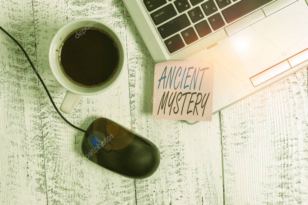 Writing note showing Ancient Mystery. Business concept for anything that is kept secret or remains unexplained Trendy metallic laptop blank sticky note coffee cup mouse lying vintage