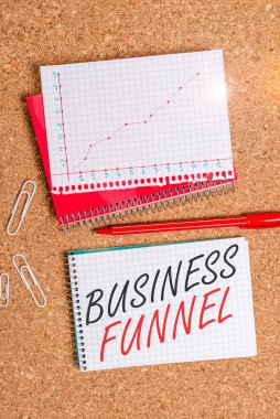 Text sign showing Business Funnel. Business photo showcasing purchasing process that businesses lead their customers Desk notebook paper office cardboard paperboard study supplies table chart