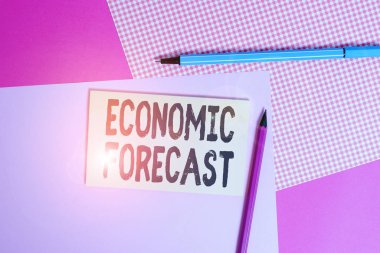 Conceptual hand writing showing Economic Forecast. Concept meaning attempting to predict the future condition of the economy writing equipments and plain note paper placed on the table