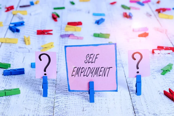 Text sign showing Self Employment. Business photo text working for oneself as a freelance or the owner of a busines Scribbled and crumbling sheet with paper clips placed on the wooden table