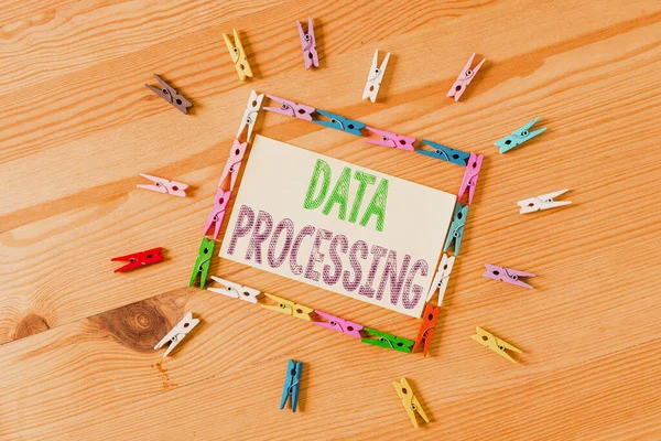 Word writing text Data Processing. Business photo showcasing collection and manipulation of items of data to produce Colored clothespin papers empty reminder wooden floor background office