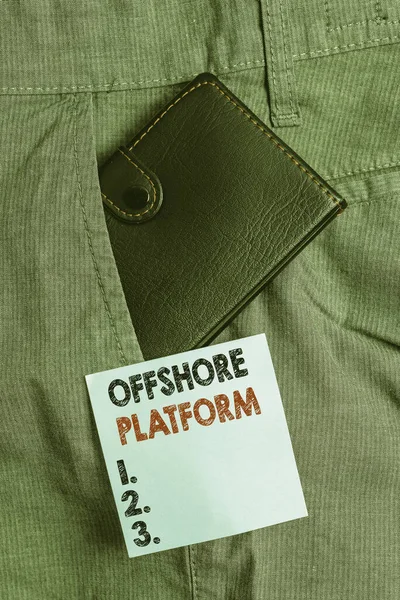 Handwriting text Offshore Platform. Conceptual photo structure with facilities for well drilling to explore Small little wallet inside man trousers front pocket near notation paper