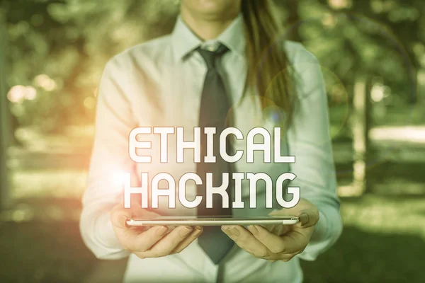 Text sign showing Ethical Hacking. Business photo showcasing act of locating weaknesses and vulnerabilities of computer Business woman in shirt with a tie holding lap top mobile phone in the hand