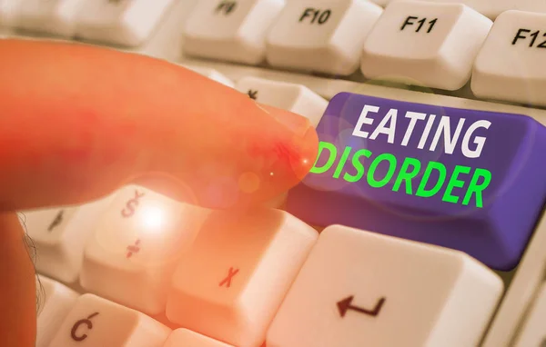 Writing note showing Eating Disorder. Business concept for illnesses that are characterized by irregular eating habits