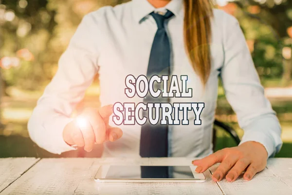 Conceptual hand writing showing Social Security. Business photo text government system that provide monetary assistance to people Female business person sitting by table and holding mobile phone.