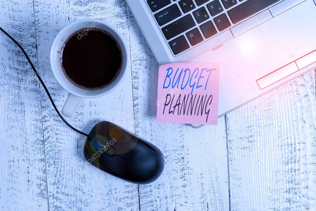 Writing note showing Budget Planning. Business concept for process of constructing a budget and then utilizing it Trendy metallic laptop blank sticky note coffee cup mouse lying vintage