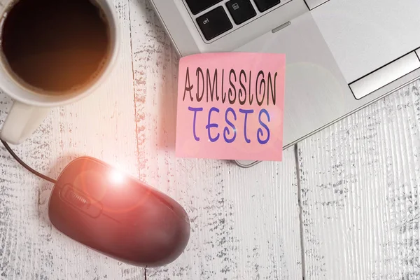Word writing text Admission Tests. Business photo showcasing an exam that you take to be accepted into a school Trendy metallic laptop blank sticky note coffee cup mouse lying vintage