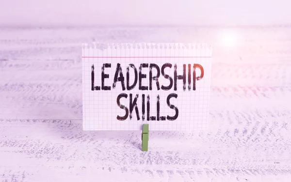 Writing note showing Leadership Skills. Business concept for Skills and qualities that leaders possess Taking a lead Green clothespin white wood background reminder office supply