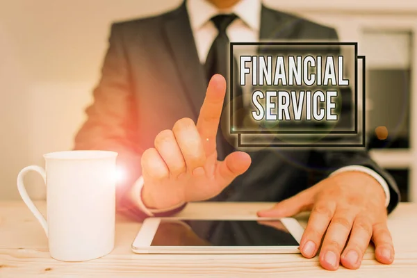 Text sign showing Financial Service. Conceptual photo economic services provided by the finance industry Male human wear formal clothes present presentation use hi tech smartphone.