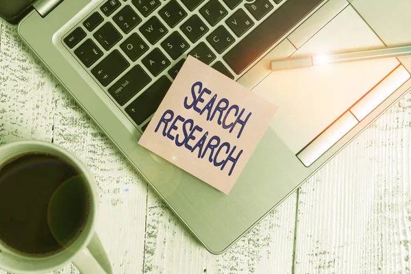 Writing note showing Search Research. Business concept for creative and systematic work taken to increase knowledge Trendy metallic laptop sticky pad pen coffee cup lying vintage table