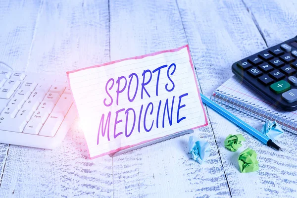 Conceptual hand writing showing Sports Medicine. Concept meaning treatment and prevention of injuries related to sports Notepaper on wire in between computer keyboard and sheets