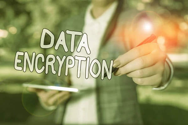 Conceptual hand writing showing Data Encryption. Concept meaning Conversion of data into code for compression or security Outdoor background business woman holding laptop and pen