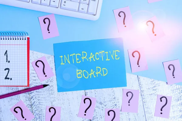Word writing text Interactive Board. Business photo showcasing standalone touchscreen computer used independently Writing tools, computer stuff and math book sheet on top of wooden table