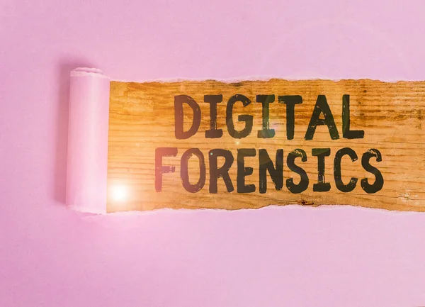 Handwriting text Digital Forensics. Concept meaning investigation of material found in digital devices Cardboard which is torn in the middle placed above a wooden classic table.