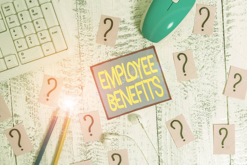Handwriting text Employee Benefits. Conceptual photo payments made to employees beyond the scope of wages Writing tools, computer stuff and scribbled paper on top of wooden table