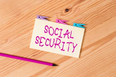 Sosyal Güvenlik 'i gösteren bir mesaj. İnsanlara para yardımı sağlayan iş fotoğrafı metni yönetim sistemi Renkli çamaşır iğnesi kağıtları boş hatırlatıcı ahşap zemin ofis