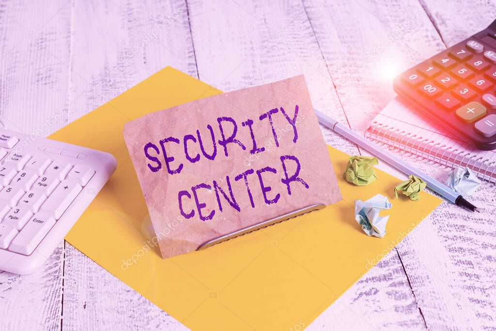 Writing note showing Security Center. Business concept for centralized unit that deals with security issues of company Notepaper on wire in between computer keyboard and sheets