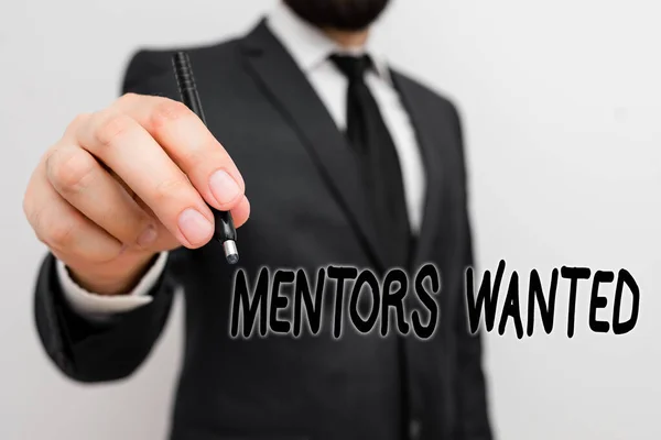 Conceptual hand writing showing Mentors Wanted. Concept meaning looking for someone who teaches or gives help and advice Male human with beard wear formal working suit clothes hand