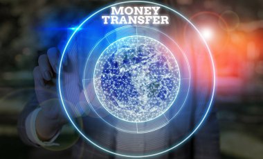 Writing note showing Money Transfer. Business concept for The act of transferring money from one place to another place Elements of this image furnished by NASA