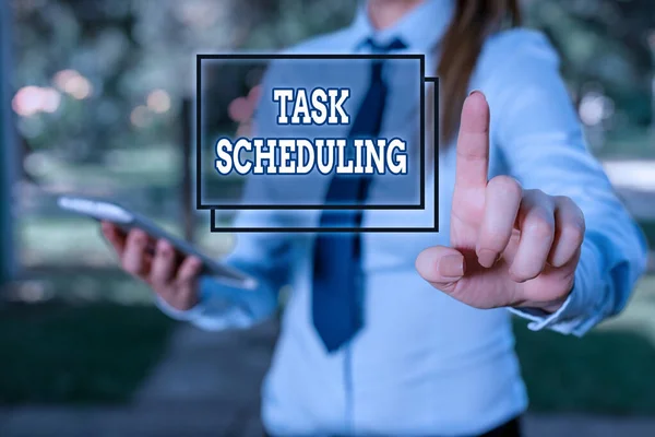 Handwriting text Task Scheduling. Conceptual photo The assignment of start and end times to a set of tasks Handsome business girl pointing with finger into empty space