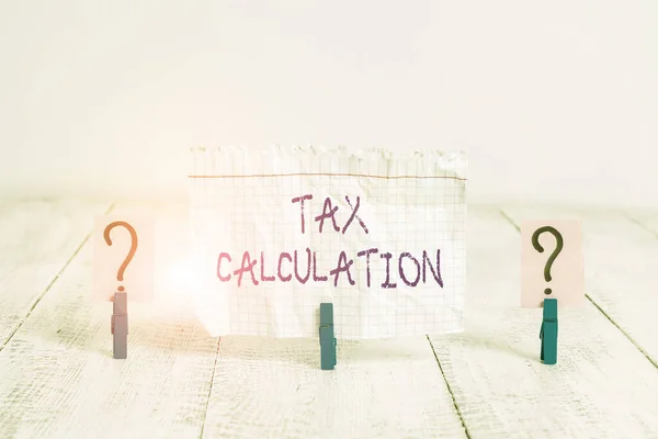 Conceptual hand writing showing Tax Calculation. Business photo showcasing an assessment of how much to pay to the government Crumbling sheet with paper clips placed on the wooden table.