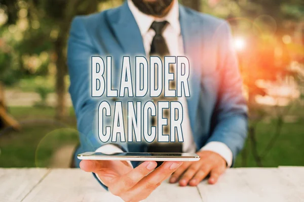 Conceptual hand writing showing Bladder Cancer. Business photo showcasing form of cancer that begins in the lining of the bladder Businessman with mobile phone in his hand.