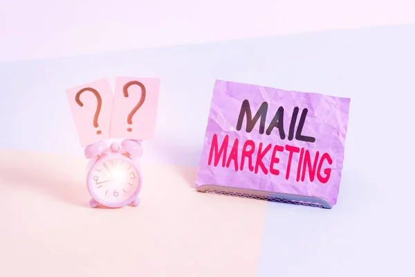 Handwriting text Mail Marketing. Concept meaning act of sending a commercial message to a group of showing Mini size alarm clock beside a Paper sheet placed tilted on pastel backdrop. — Stock Photo, Image