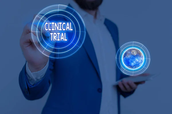 Handwriting text Clinical Trial. Concept meaning trials to evaluate the effectiveness and safety of medication Elements of this image furnished by NASA.