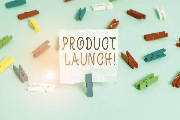 Conceptual hand writing showing Product Launch. Business photo text process to introduce new product for sale for the first time Colored clothespin papers empty reminder blue floor officepin. — Stockfoto