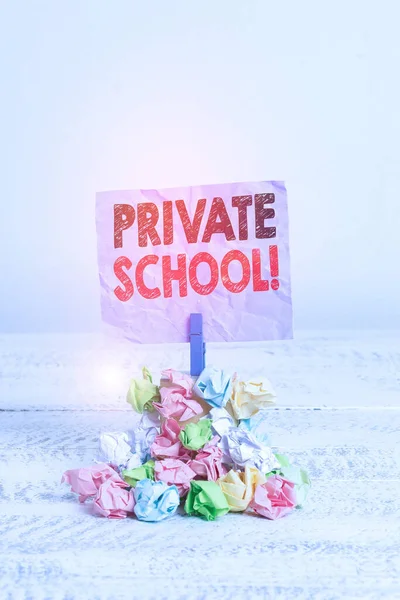 Writing note showing Private School. Business photo showcasing an independent school supported wholly by the payment of fees Reminder pile colored crumpled paper clothespin wooden space.